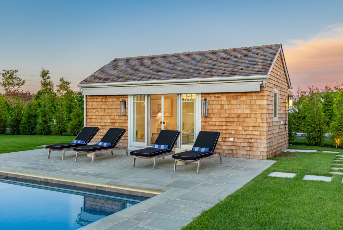 Pool House With Chaise Lounges At Sunset – Backyard