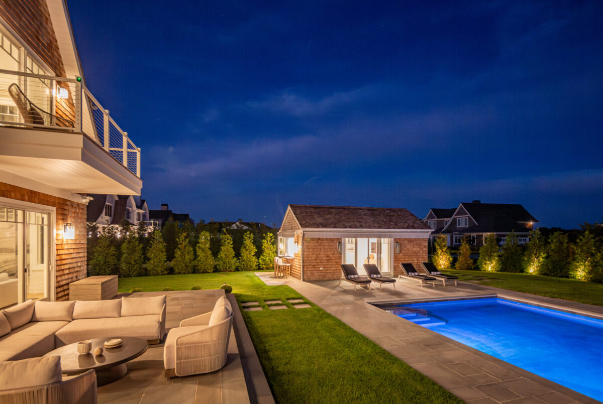 Outdoor Terrace & Pool House At Dusk – Backyard